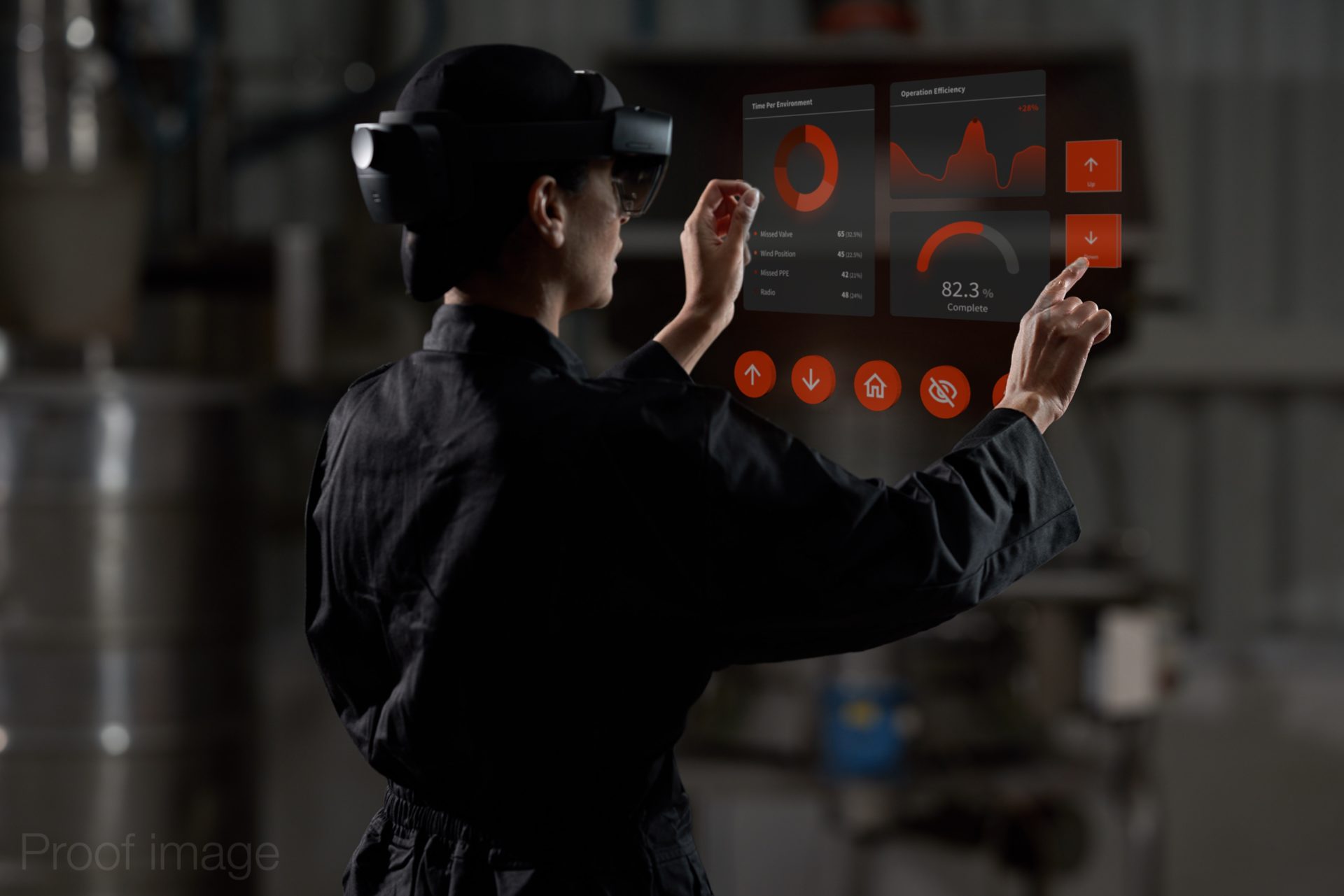 woman in black overalls and mixed reality headset viewing a virtual dashboard of analytics in a factory